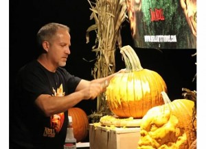 Jon Neill carves a pumpkin