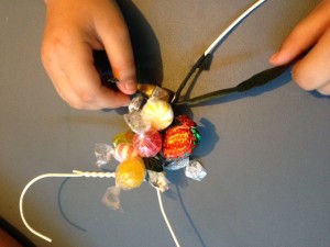 Attaching candy to the wreath